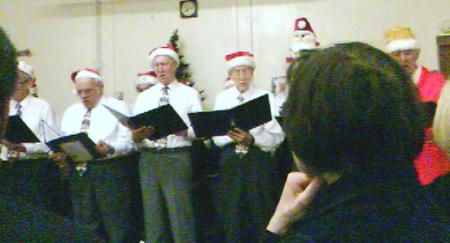 male choir in their santa hats